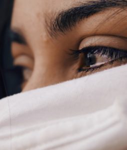 Image of an eye filled with tears of a person in a toxic work environment.